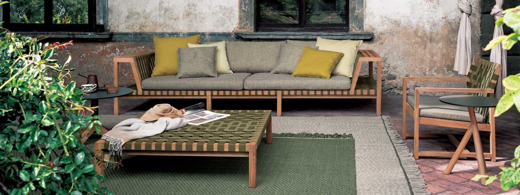 Image of RODA Network teak garden sofa with Olive webbing on outdoor terrace