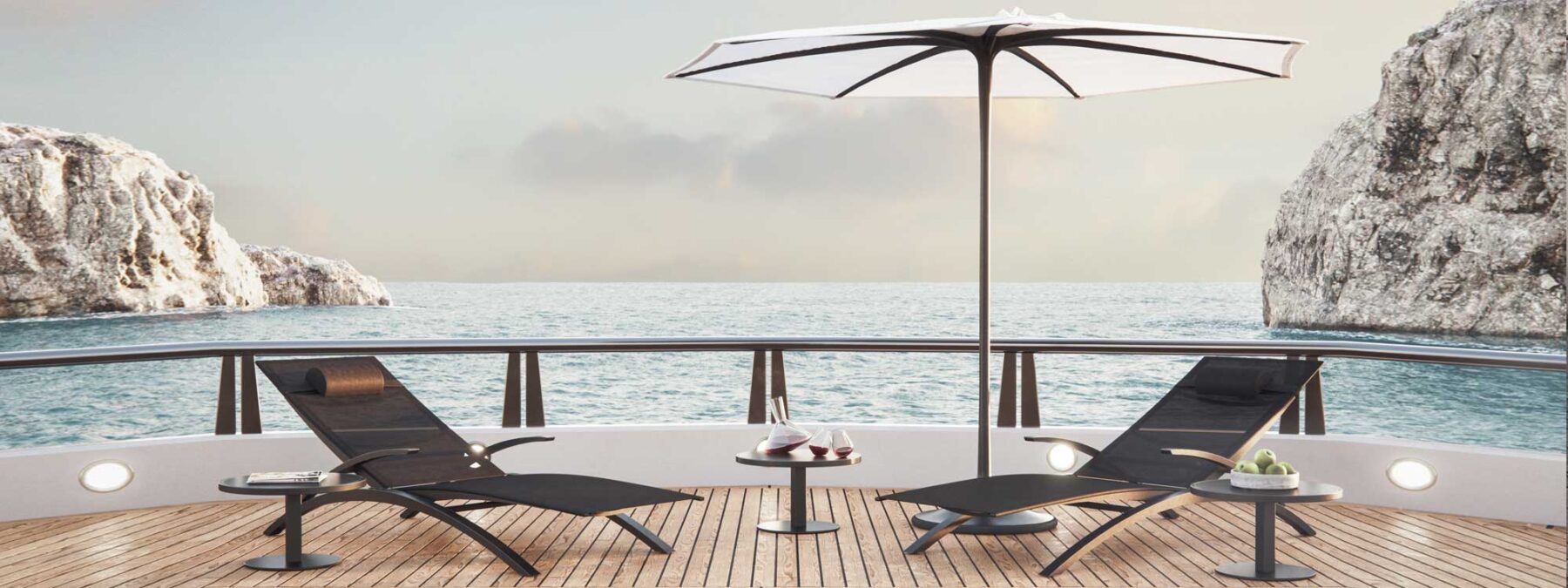Image of pair of black OZON sun loungers by Royal Botania on teak aft deck of superyacht