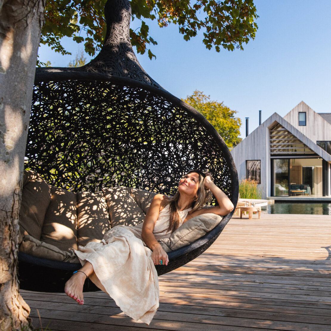 Image of Gemma luxuriating inside Bios Hide luxury swing seat, photgraphed at the Watershed, Bosham