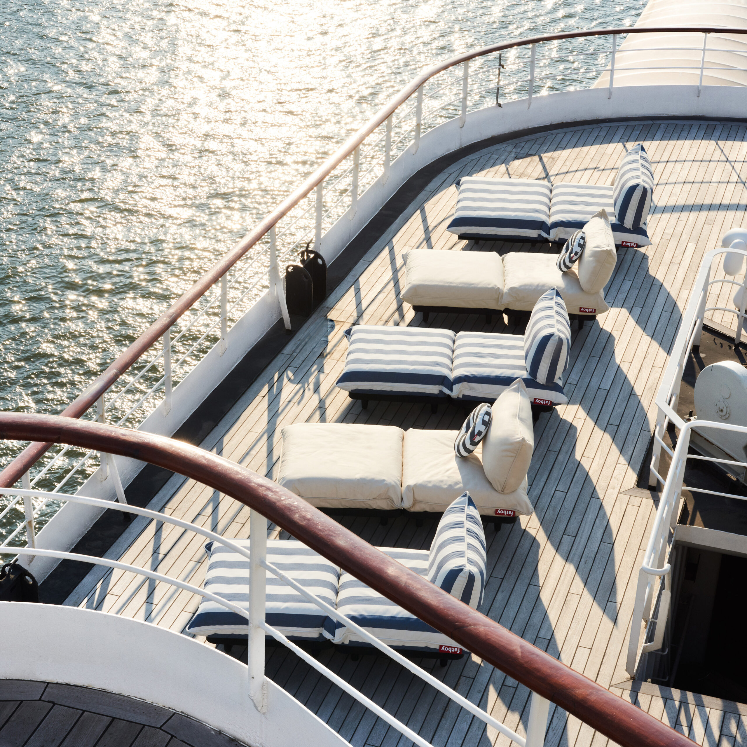 Image of row of Fatboy Paletti daybeds on deck of ship