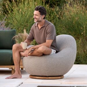 Image of man relaxing in Cane-line Gem swivel lounge chair